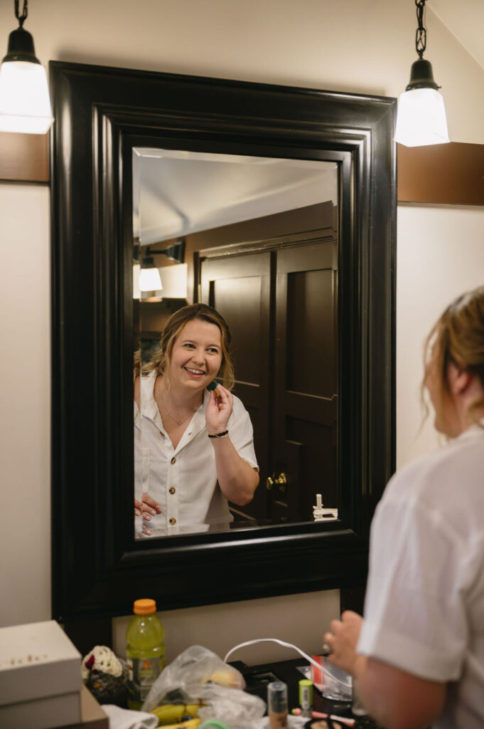 bride applying makeup