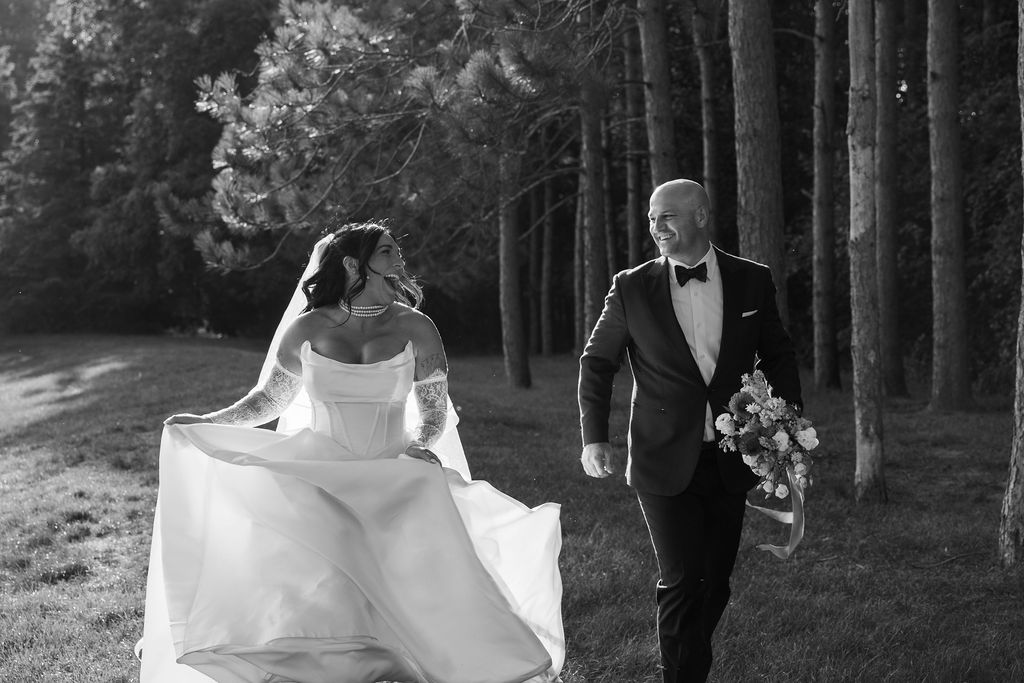 bride and groom running through trees at belvedere estate