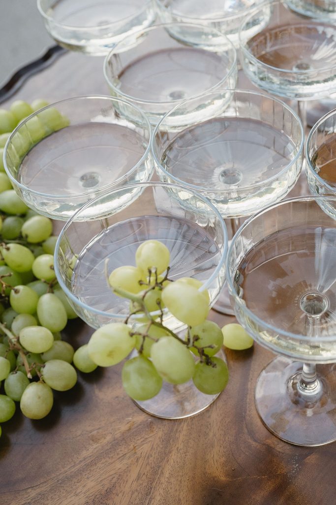 champagne glasses filled with grapes