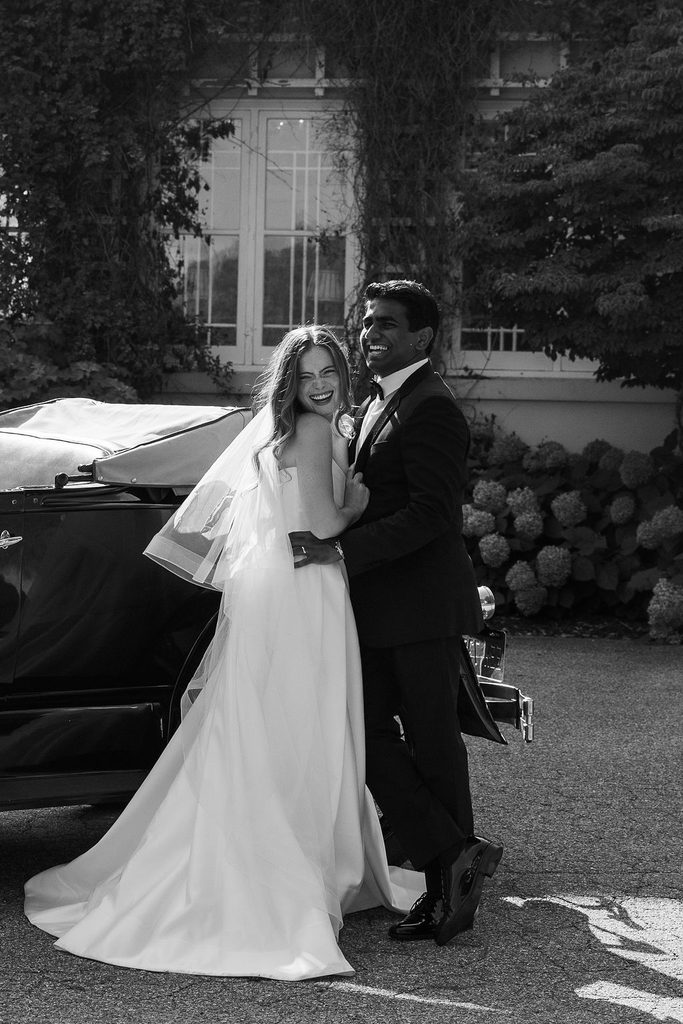 bride and groom hugging outside of belvedere estate